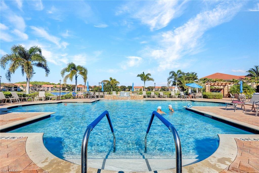 Community pool with a patio area and a pergola