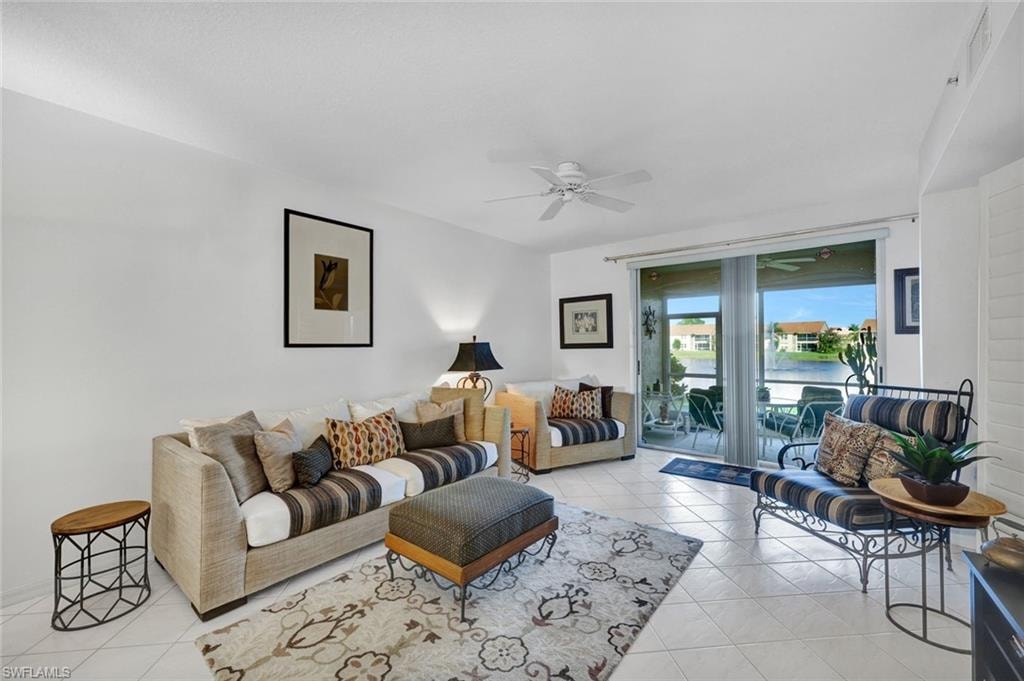 Living area featuring light tile patterned flooring and ceiling fan