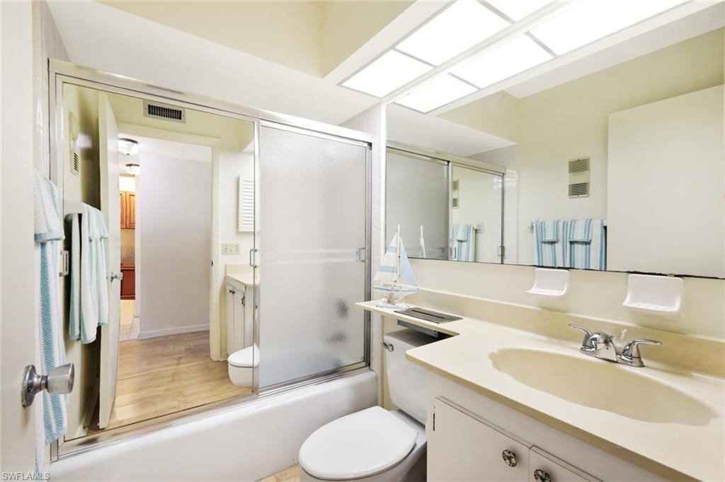 Full bathroom with vanity and shower / bath combination with glass door