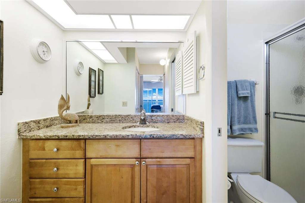 Ensuite bathroom featuring vanity and a shower stall