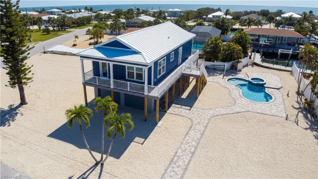 Virtually EDITED  Drone shot Front view of house with pool & spa on canal- Before actual landscaping done- -VIRTUALLY EDITED