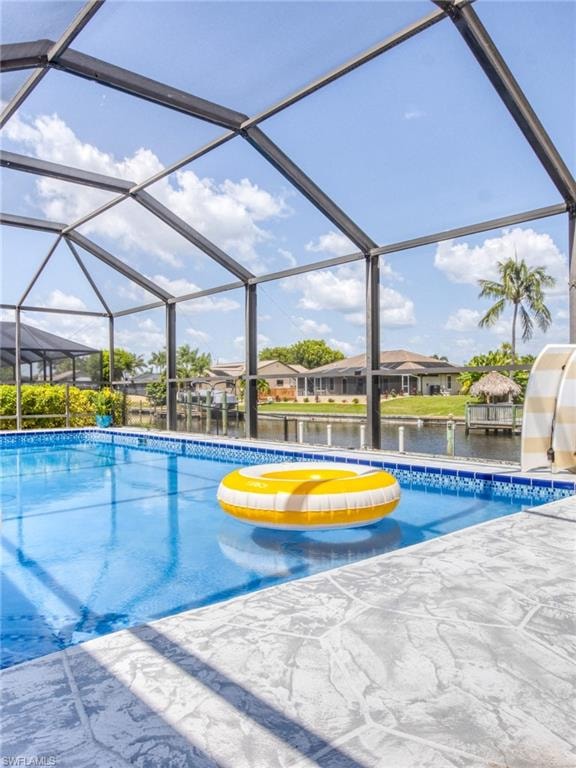 Swimming pool with a lanai, a sunroom, a water view, and a residential view