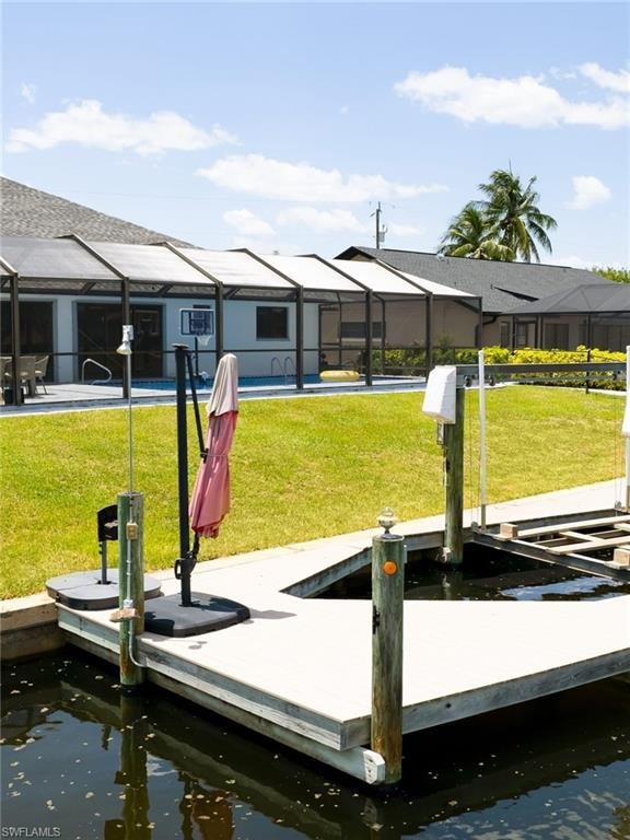 Dock area with a sunroom, a yard, and glass enclosure