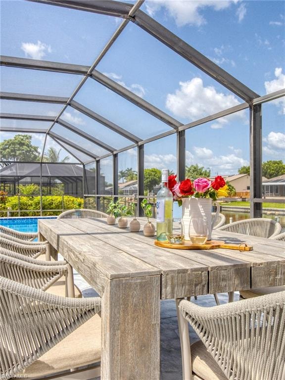 View of patio / terrace with glass enclosure, a sunroom, and an outdoor pool