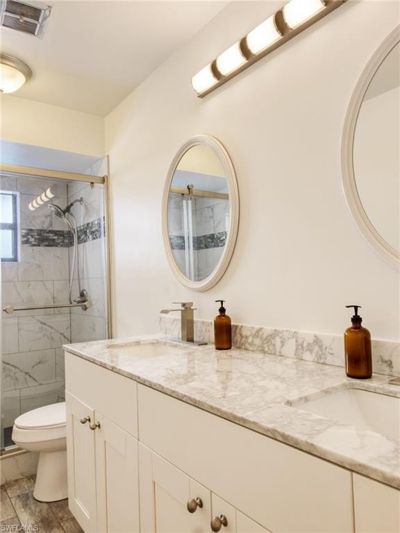 Bathroom with a marble finish shower and double vanity