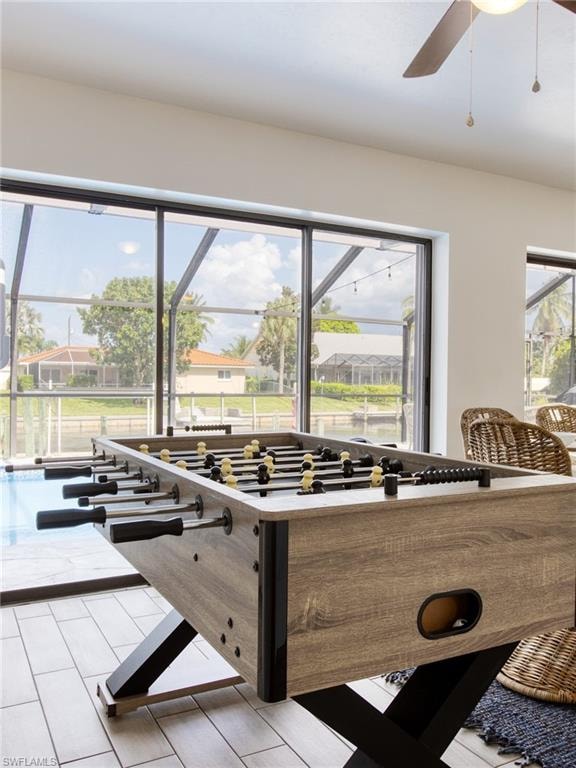 Playroom with plenty of natural light and a ceiling fan
