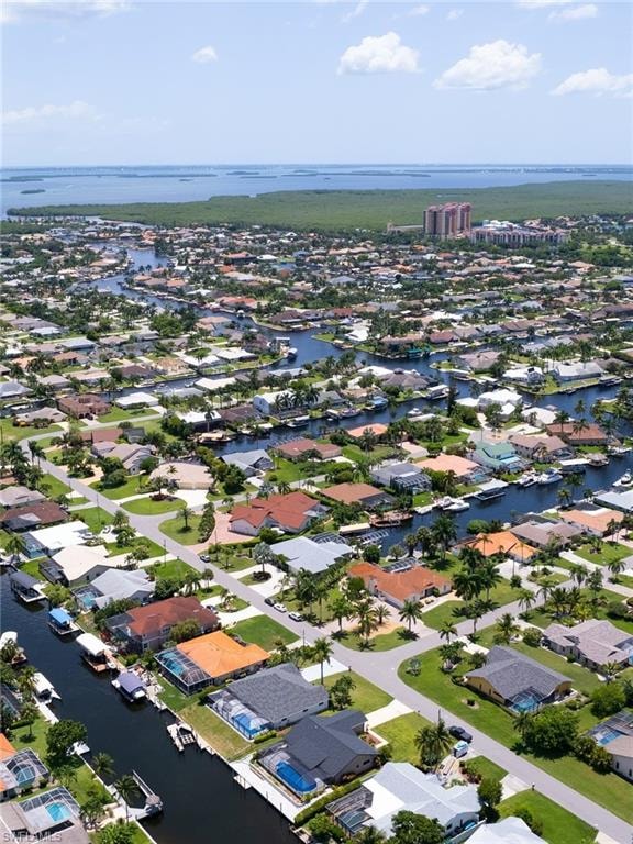 Aerial view of residential area featuring a nearby body of water