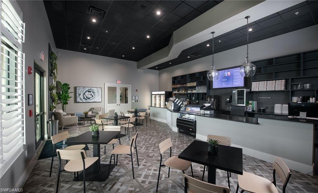 Dining area with a towering ceiling and recessed lighting