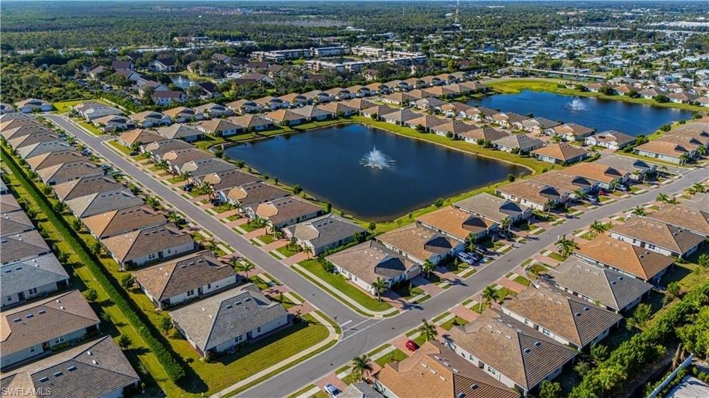 Aerial view of property and surrounding area with nearby suburban area and a nearby body of water