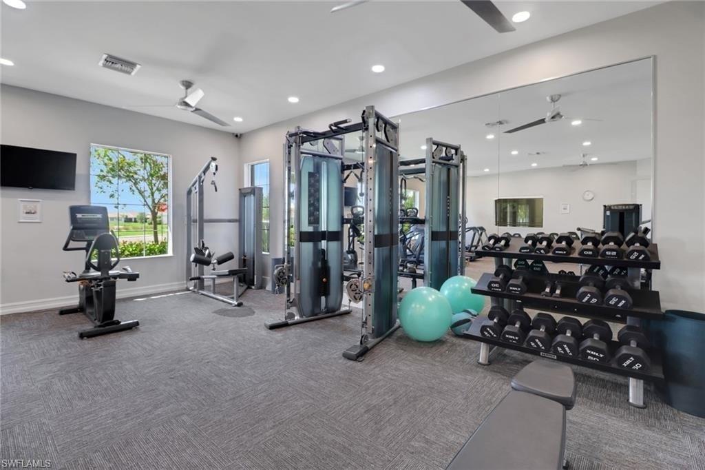 Exercise room featuring a ceiling fan and recessed lighting