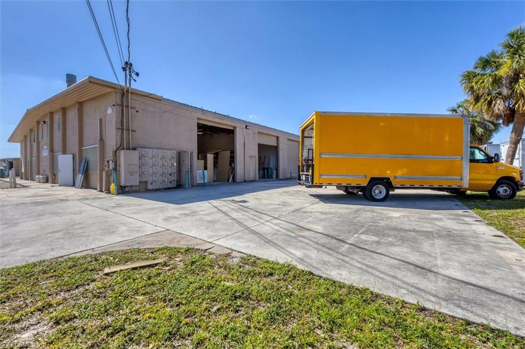 Front of business including truck and overhead doors.