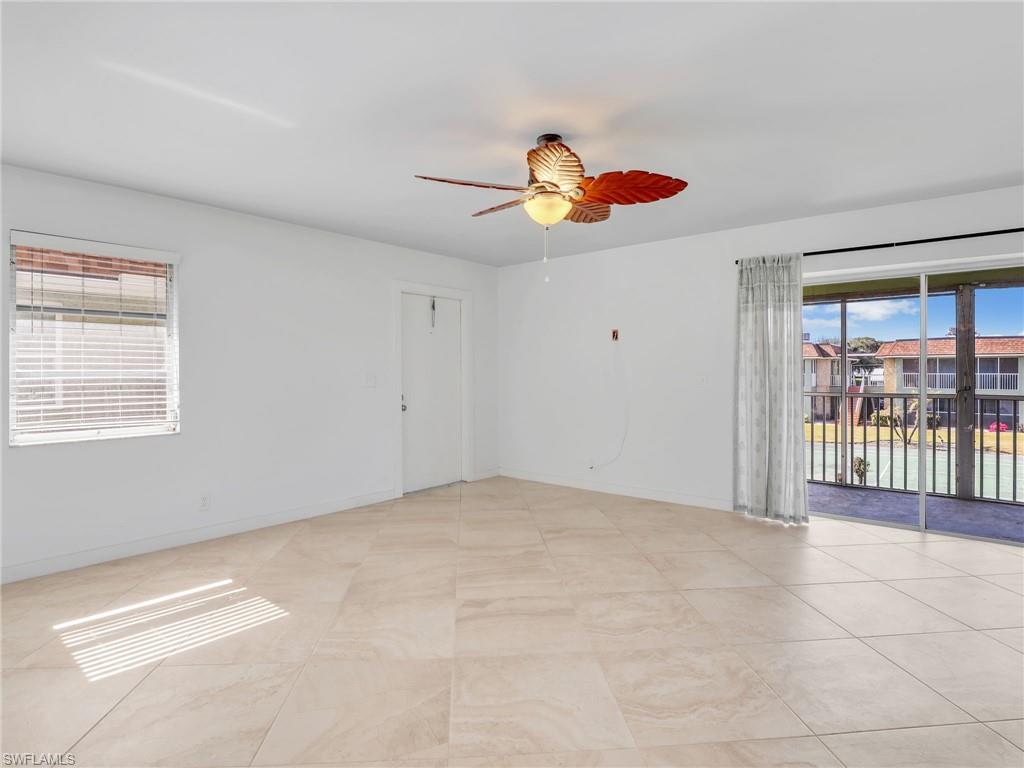 Unfurnished room featuring healthy amount of natural light and a ceiling fan