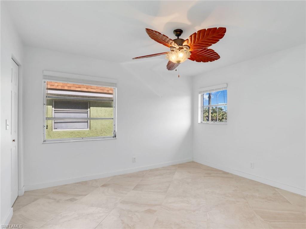Unfurnished room featuring baseboards and a ceiling fan