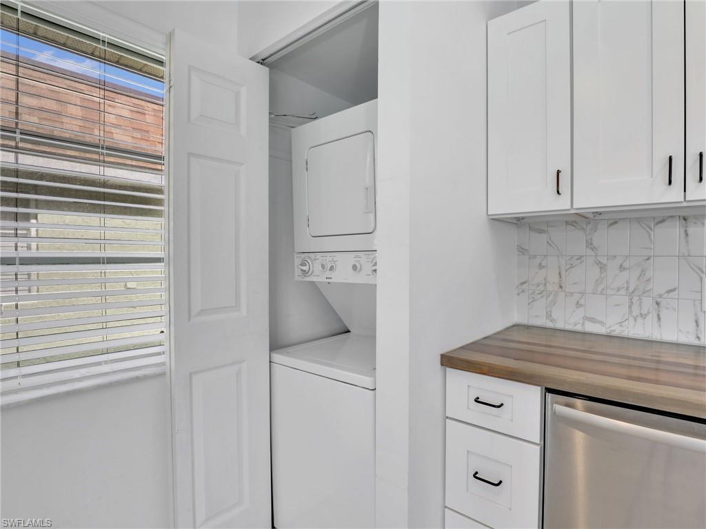 Laundry room with stacked washer and clothes dryer