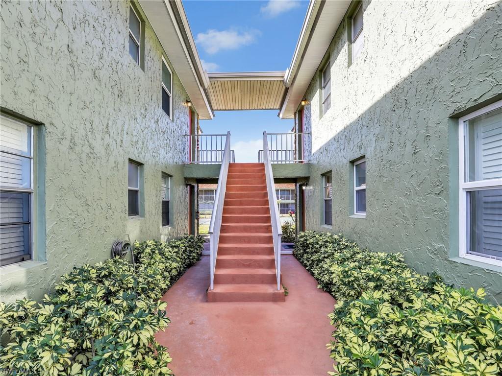 View of property's community with stairs and a balcony