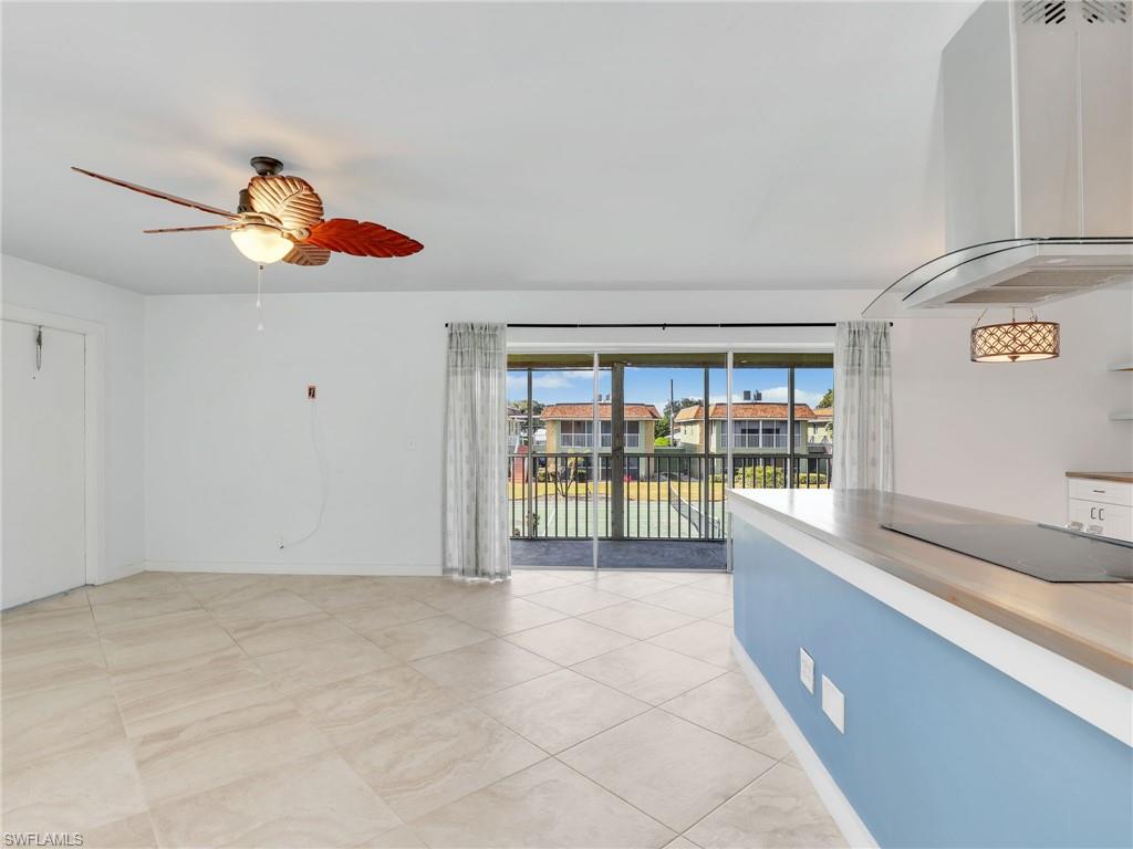 Spare room featuring ceiling fan, a residential view, and light tile patterned flooring
