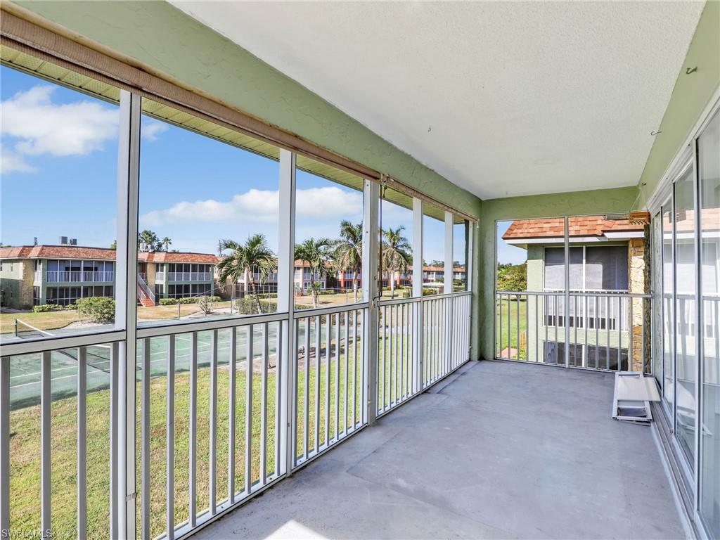 Unfurnished sunroom featuring a balcony