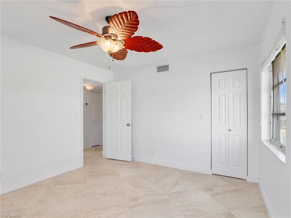 Unfurnished bedroom featuring a ceiling fan and baseboards