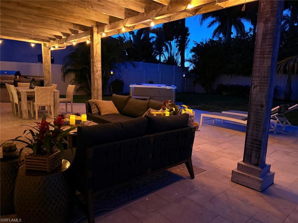Patio at twilight featuring outdoor dining space, an outdoor hangout area, a fenced backyard, and a patio area