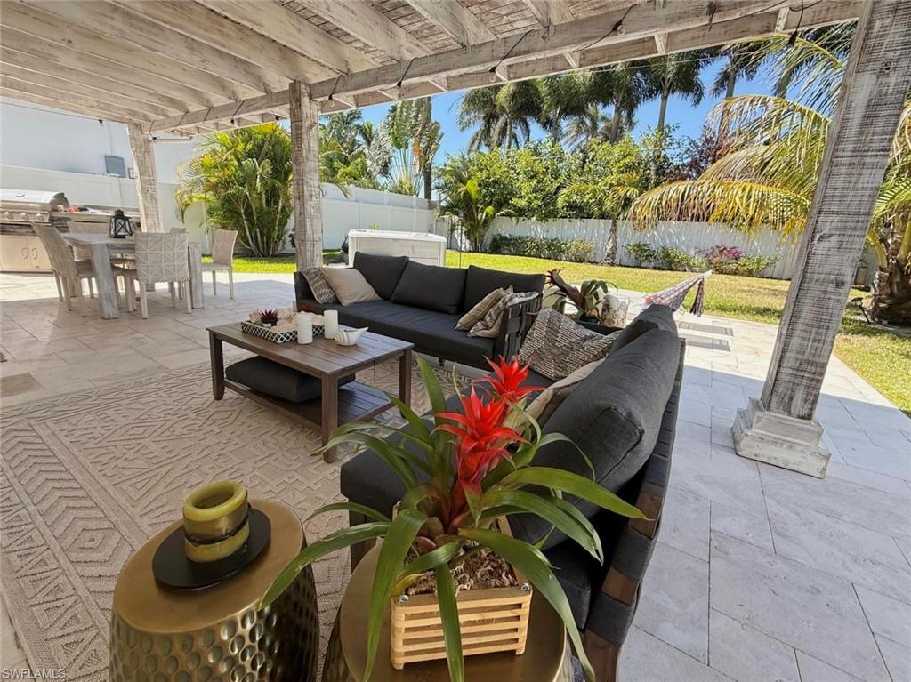 Fenced backyard with outdoor dining area, an outdoor hangout area, a patio, and grilling area