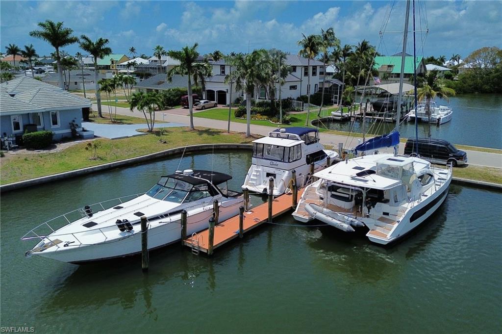 Dock area with a water view and a residential view