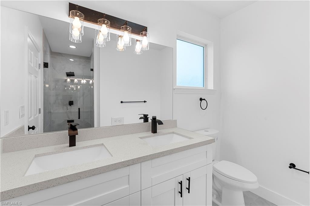 Bathroom with a stall shower and double vanity