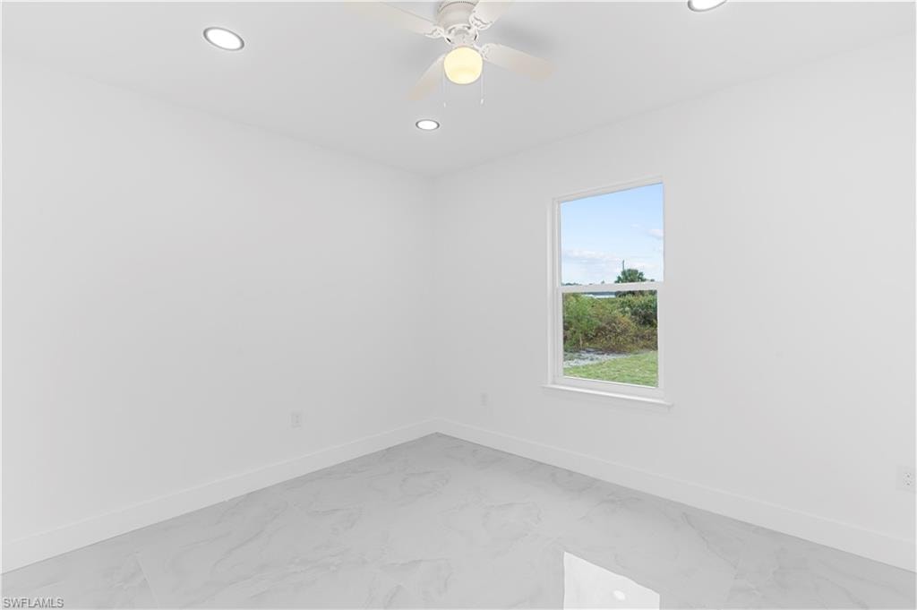 Unfurnished room featuring light marble finish flooring, recessed lighting, and ceiling fan