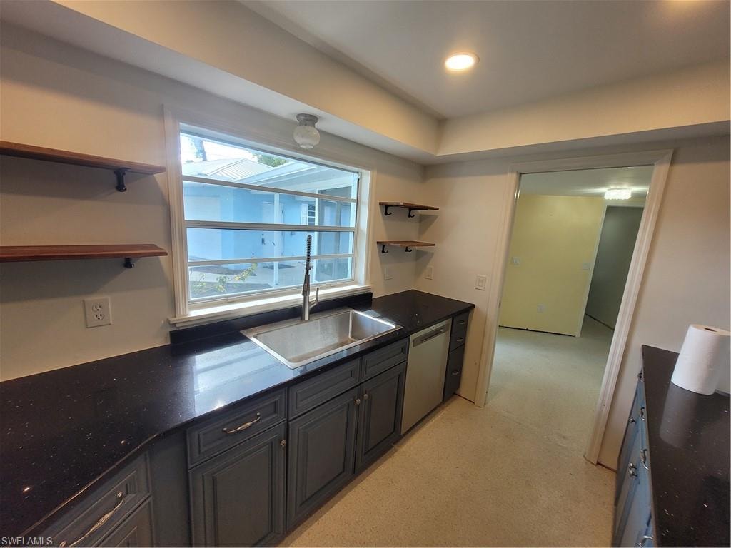 Kitchen featuring open shelves, dishwasher, light carpet, dark stone counters, and recessed lighting