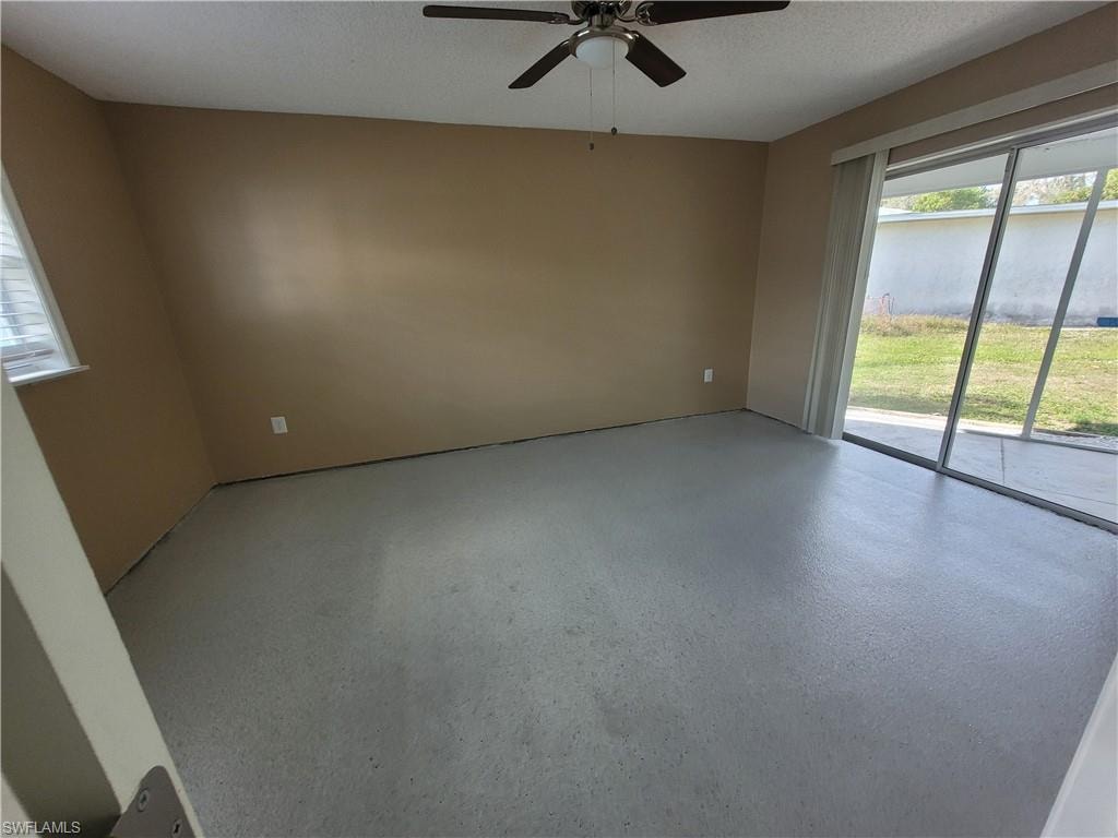 Unfurnished room featuring a textured ceiling and ceiling fan
