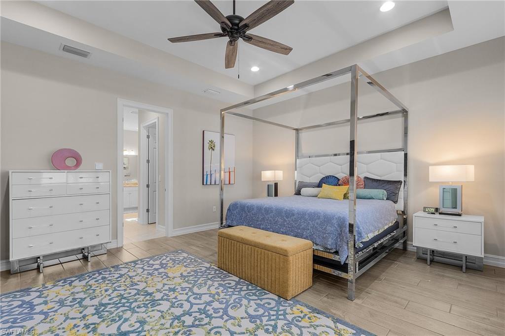Primary Bedroom featuring wood finish floors, ceiling fan, and recessed lighting