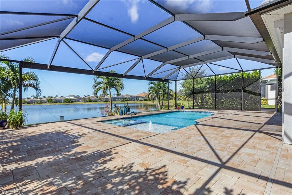 Swimming pool featuring screened enclosure, a sunroom, a huge lake view, and a patio