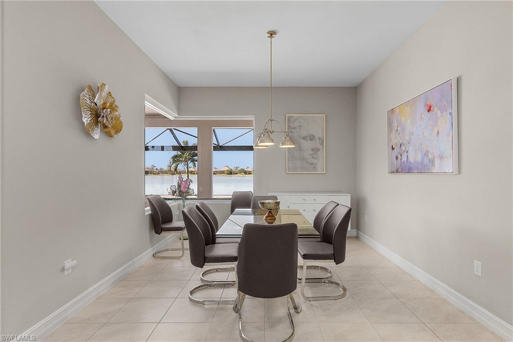 Dining room with light tile patterned floors and a water view