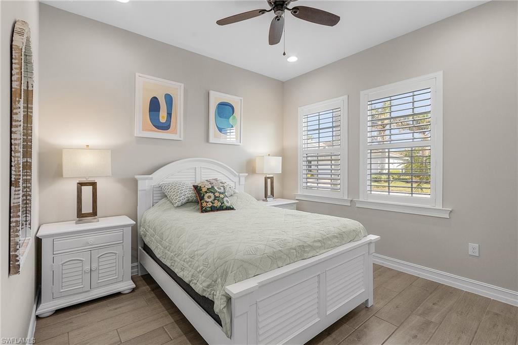 Bedroom featuring light wood-style floors, a ceiling fan, and recessed lighting