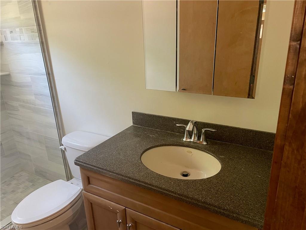 Bathroom featuring vanity and a shower stall