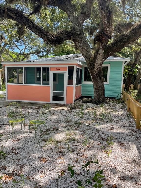 View of front of home featuring a sunroom