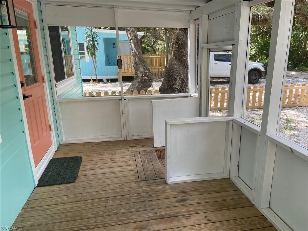 Unfurnished sunroom featuring hardwood / wood-style floors