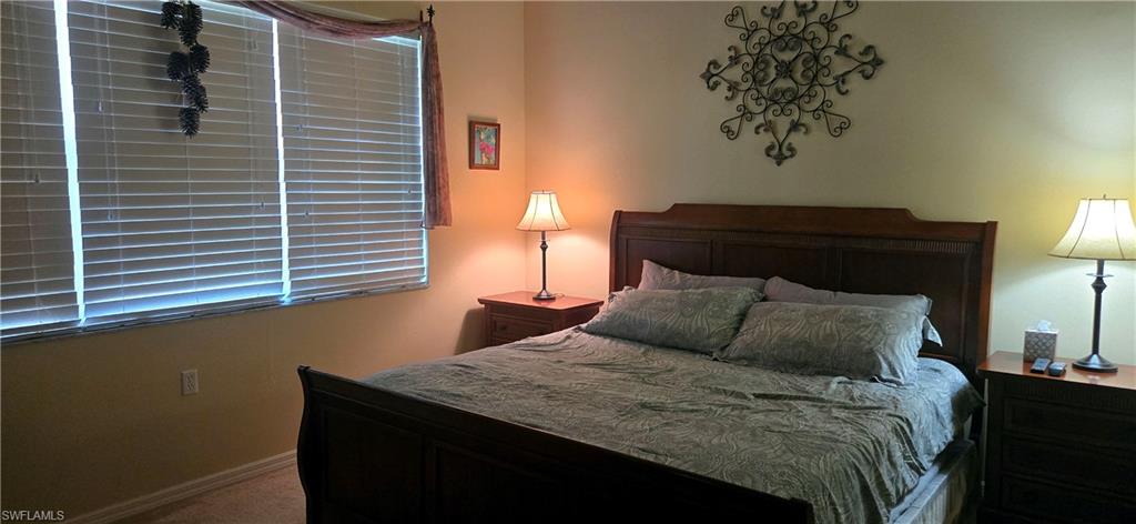 Carpeted bedroom featuring baseboards