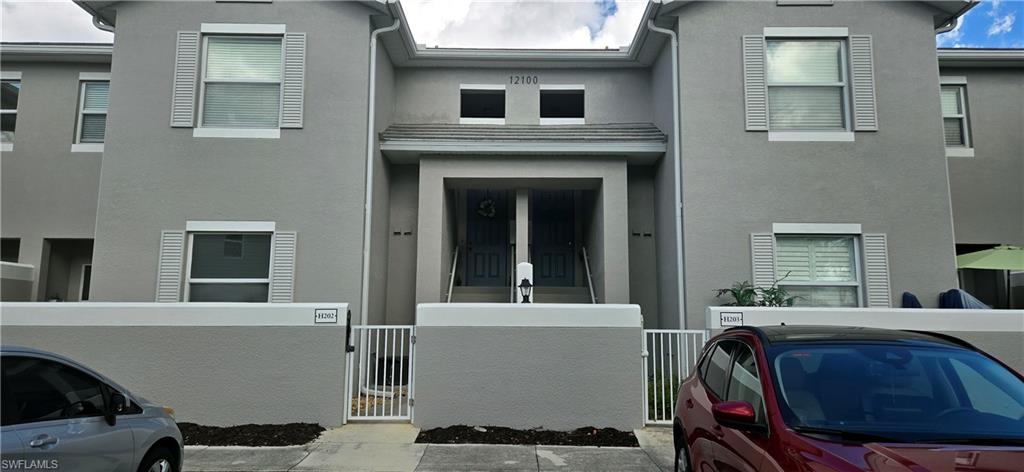 View of front facade featuring stucco siding.