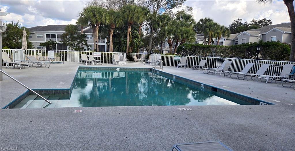 Community pool featuring a patio area and a residential view