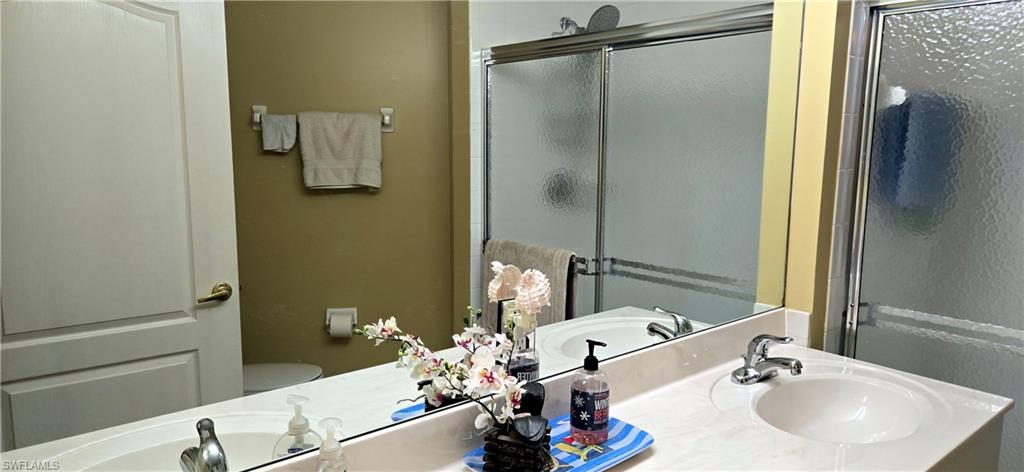 Bathroom with a shower stall and double vanity