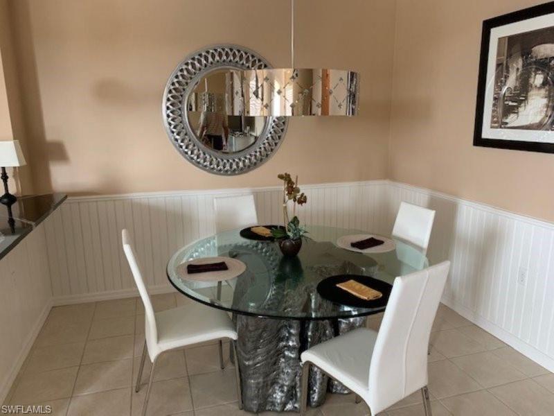 Dining area featuring wainscoting and light tile patterned floors
