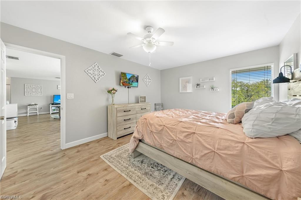 Bedroom with light wood-style floors and ceiling fan