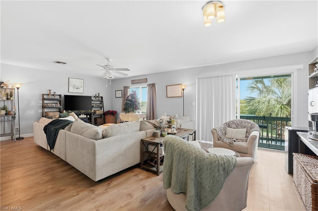Living area with light vinyl style flooring and a ceiling fan