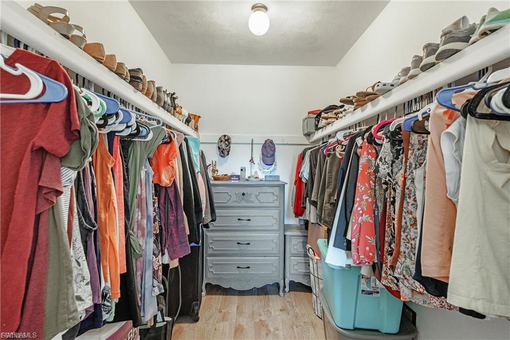 Spacious closet featuring light wood-style flooring