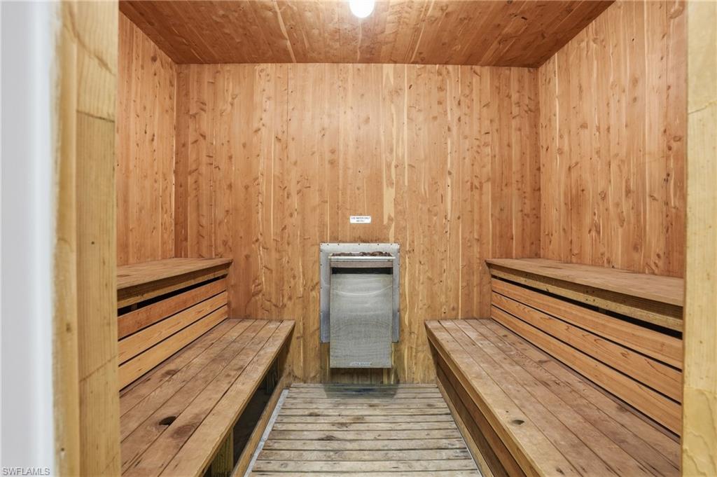 Sauna / steam room featuring wood ceiling and wooden walls