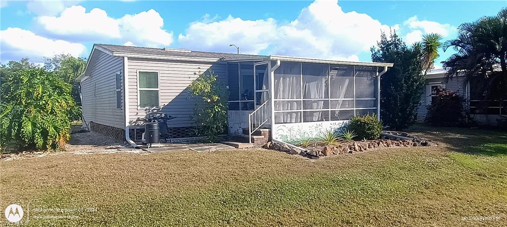 View of outbuilding with a sunroom