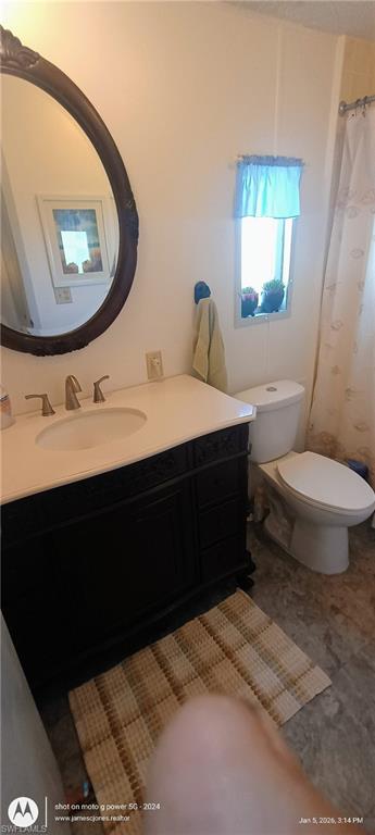 Bathroom featuring vanity and curtained shower