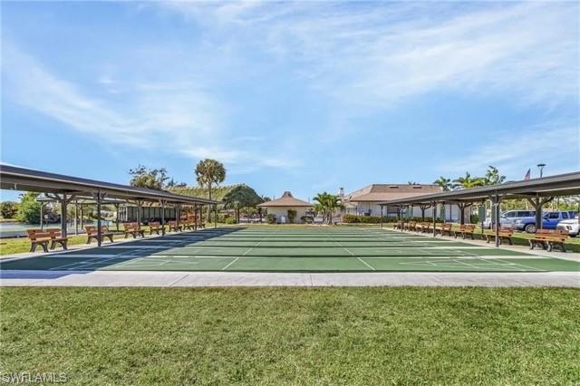 Multiple shuffleboard courts featuring a covered seating area