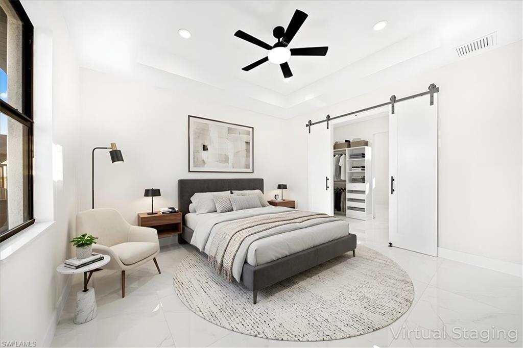 Office space with ceiling fan, light marble finish floors, and recessed lighting