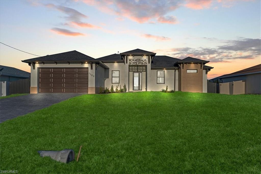 Prairie-style house featuring driveway, stucco siding, and an attached garage